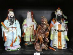 Three 20th century Chinese figures and one other carved wooden figure