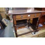 An antique oak side table having one drawer on turned legs