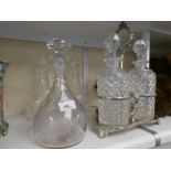 A silver plated three bottle decanter stand, a vine engraved decanter and a pair of Stuart decanters