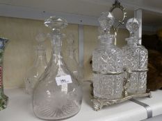 A silver plated three bottle decanter stand, a vine engraved decanter and a pair of Stuart decanters