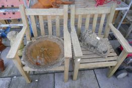 Two weathered teak garden armchairs