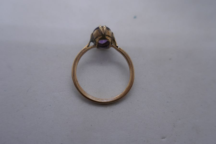 Unmarked yellow metal dress ring set with a single oval amethyst stone, size N, unmarked. 1.9g - Image 2 of 4