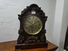 A Victorian mahogany bracket clock having carved floral and acanthus leaf decoration by William Ross