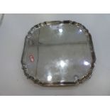 A heavy silver salver with four whorl feet, great quality. Hallmarked Sheffield 1964 C J