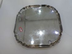 A heavy silver salver with four whorl feet, great quality. Hallmarked Sheffield 1964 C J