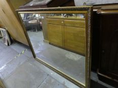 A modern gilt wall mirror