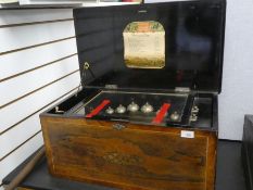 An Edwardian inlaid Rosewood musical box having 12 Airs, with 6 belts