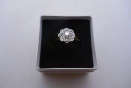 18ct yellow gold ring with diamond inset flower head central diamond approx 0.25carrat broken at sho