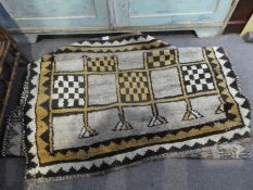 A Persian tribal Gabbeh runner having chequered design, 330 x 110cms