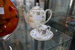 A Royal Worcester teapot and matching cup and saucer