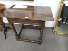 An antique oak side table having one draw on turned legs, with lower stretcher, probably early 19th