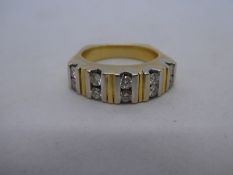 Yellow metal, possibly 18ct yellow gold, band ring inset with 10 approx .10 carat diamonds, unmarked