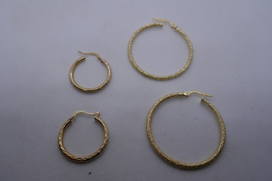 Two pairs of 9ct yellow gold hoop earrings, both marked 375, the largest pair 3cm diameter