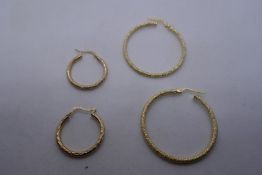 Two pairs of 9ct yellow gold hoop earrings, both marked 375, the largest pair 3cm diameter