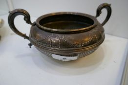A very nice two handled silver Victorian bowl of half reeded design and decorative, ornate bow detai