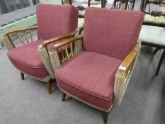 A pair of 1950s open armchairs having splay legs