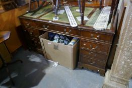 A reproduction mahogany twin pedestal desk having