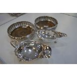 A pair of silver edged coasters with pierced foliate design. Hallmarked London 1971 Roberts and Dore