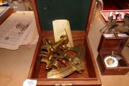 A bras sextant in box with a boxed brass magnified clock