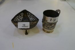 Two Indian white metal items to include a repoussé pattern animal cup with handle and chased border