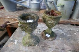 A pair of small sandstone urns