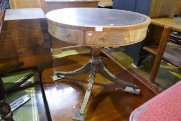 A reproduction mahogany drum table having one drawer on carved base