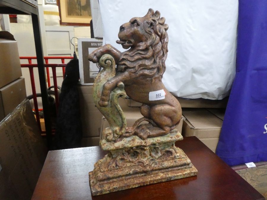 An old cast iron doorstop of seated lion