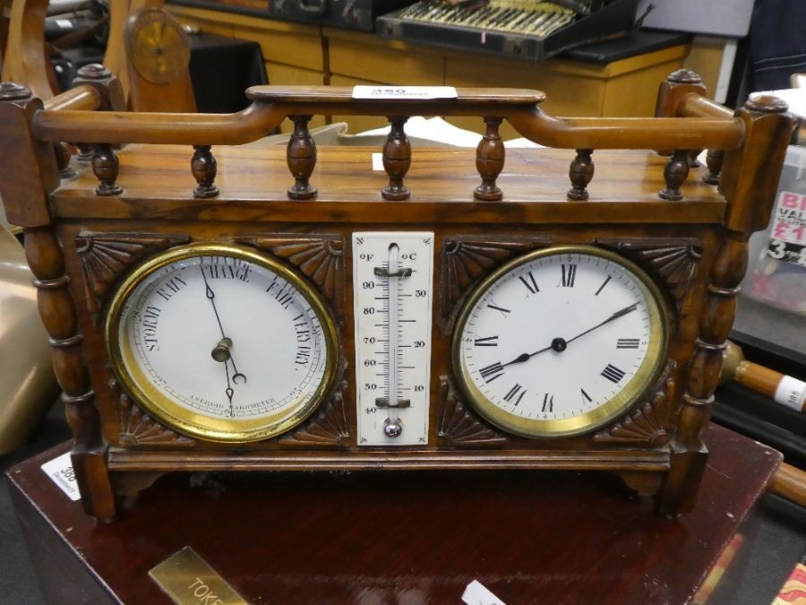 An early 20th century, clock barometer and thermometer set in carved wooden case with balustrade
