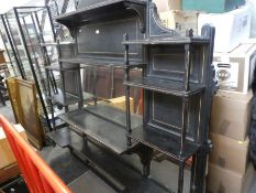 A late 19th century, ebonized and gilt decorated oval mantle mirror having numerous shelves 177cm wi