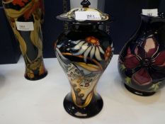 Moorcroft, a ginger jar with cover, decorated flowers and butterflies, 2005, 23cm