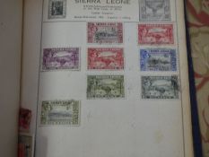 An old stamp album containing GB & Worldwide examples from 19th century and later, a small quantity