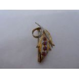 9ct yellow gold brooch in the form of a floral spray inset with rubies and diamonds, marked 375, 3.8