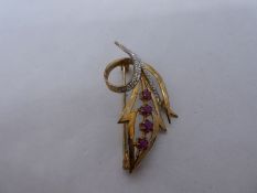 9ct yellow gold brooch in the form of a floral spray inset with rubies and diamonds, marked 375, 3.8