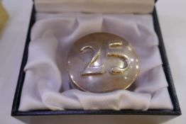 A large Sterling silver cased paperweight with '25' on the top, on low relief. Hallmarked London wit