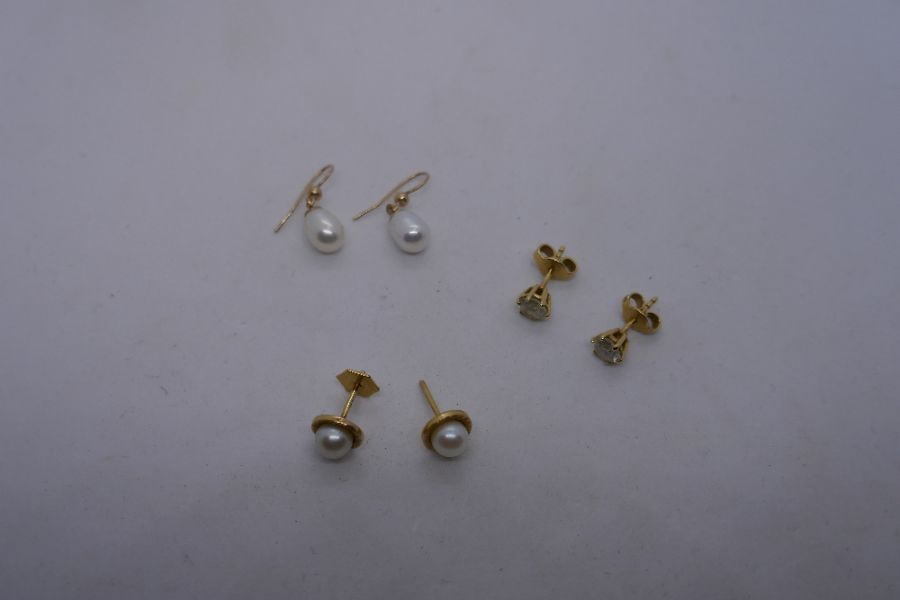 Two pairs of 18ct earrings one, being natural pearl example and a pair of 9ct yellow gold pearl stud