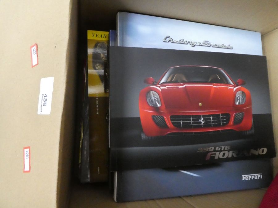 A box of Ferrari brochures and similar items