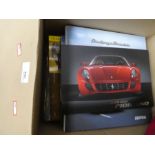 A box of Ferrari brochures and similar items