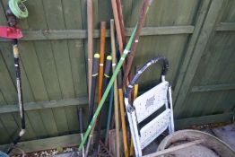 Collection of long handled garden tools and a pair of steps