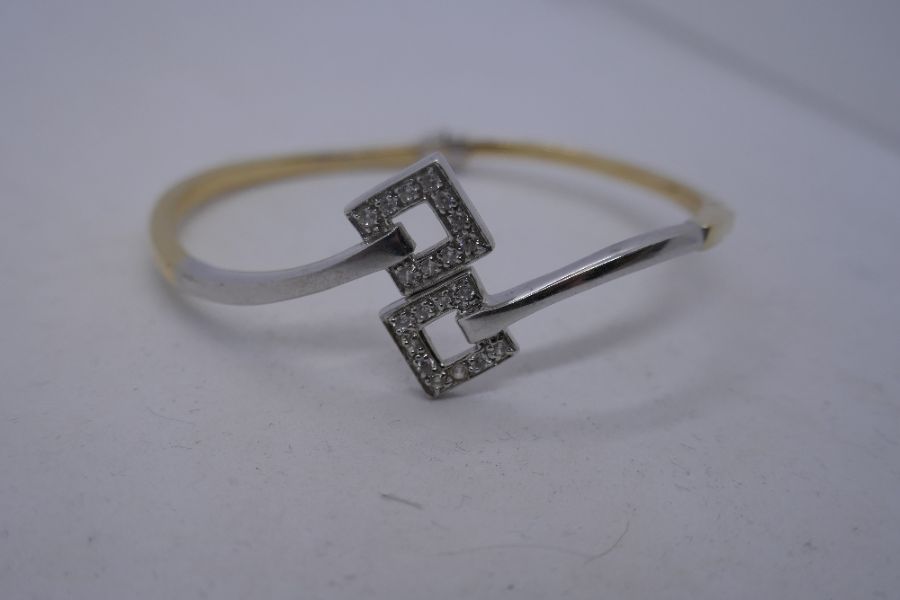 14K two tone hinged bangle with crossover geometric panels set with cubic zirconia, marked 585, 7cm