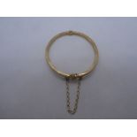 9ct yellow gold bangle, with safety chain, marked 375, 5.7g approx