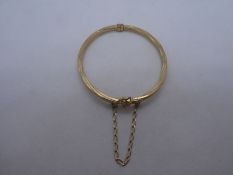 9ct yellow gold bangle, with safety chain, marked 375, 5.7g approx