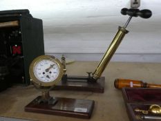 An old brass vacuum pump by Beker & Co and an old brass ship's log