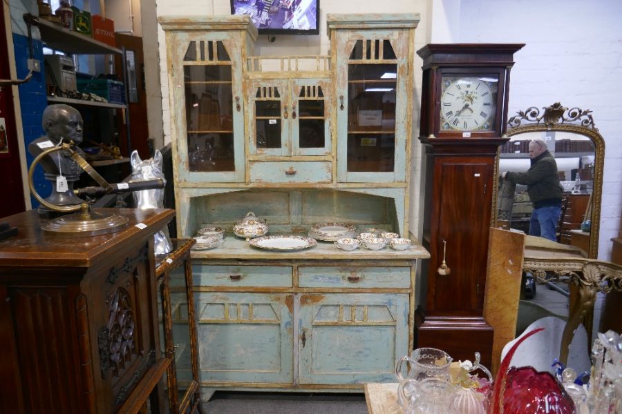 An old pine kitchen dresser having distressed paintwork, the top having glazed doors, 141.5cm
