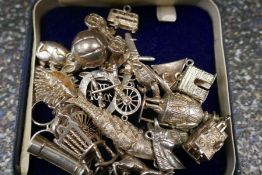 Collection of various silver charms, including Hedgehog, articulated fish, caravan, spinning wheel,