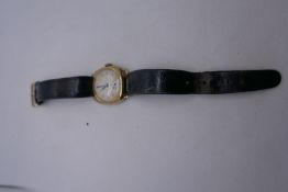 Vintage gents gold cased watch with champagne dial on black leather strap