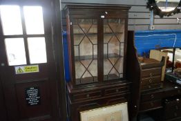 A reproduction mahogany bookcase having cupboard base