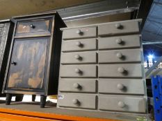 Bank of twelve drawers and a distressed painted bedside cabinet