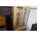 A modern pine bookcase having glazed doors with cupboard under, a repro mahogany bookcase and a pair