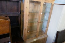 A modern pine bookcase having glazed doors with cupboard under, a repro mahogany bookcase and a pair