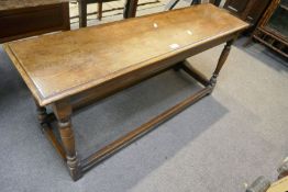 A repro oak oblong bench having lower stretches 121.5cm